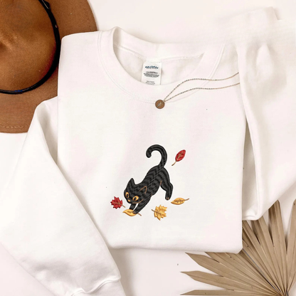 Black Cat Pouncing Autumn Leaves Sweater