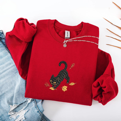 Black Cat Pouncing Autumn Leaves Sweater